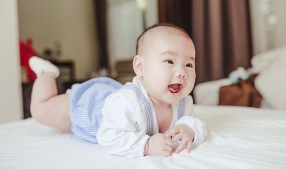 Trẻ 6 tháng thường biết cười thành tiếng khi được cha mẹ trêu đùa hoặc tương tác tích cực